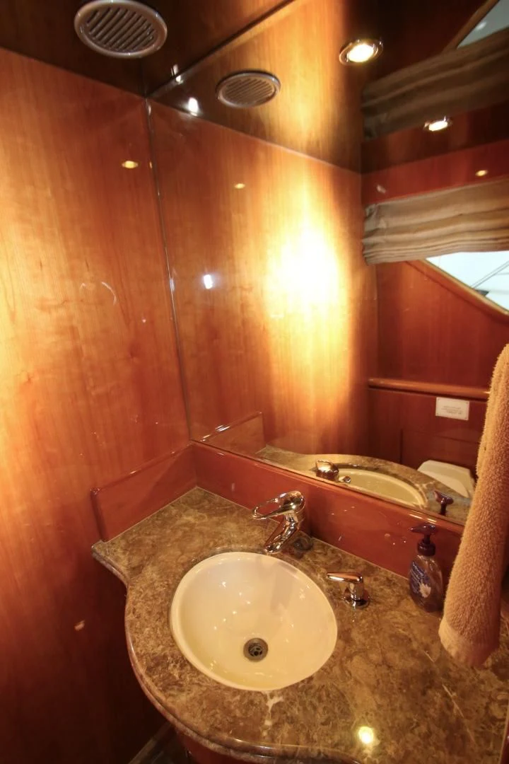 a bathroom with a sink and a mirror aboard KISMET Yacht for Sale