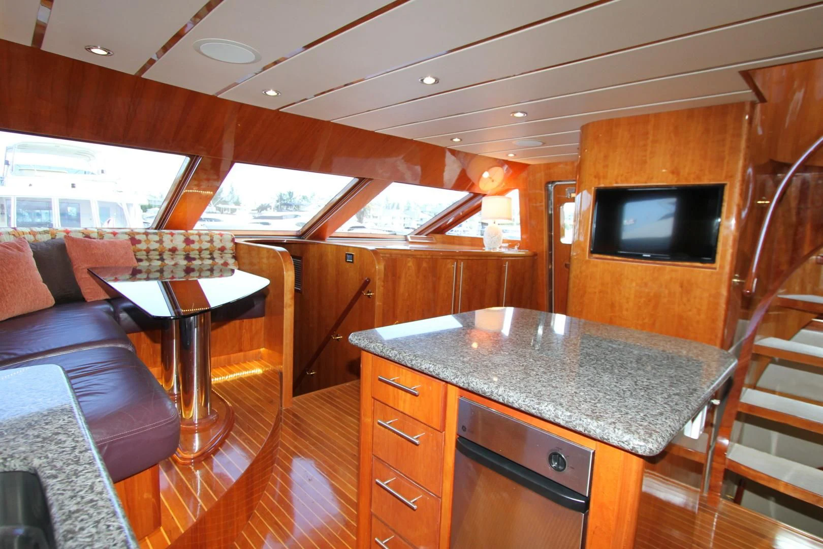 a kitchen with a bar and a table aboard KISMET Yacht for Sale