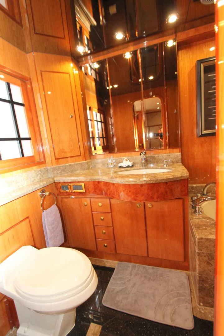 a bathroom with a toilet and a sink aboard KISMET Yacht for Sale