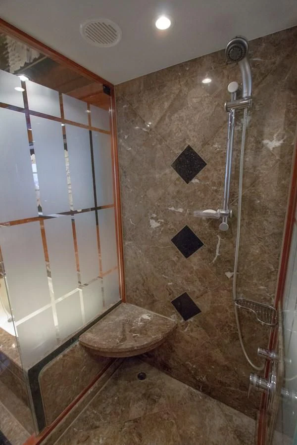 a bathroom with a shower and a sink aboard KISMET Yacht for Sale