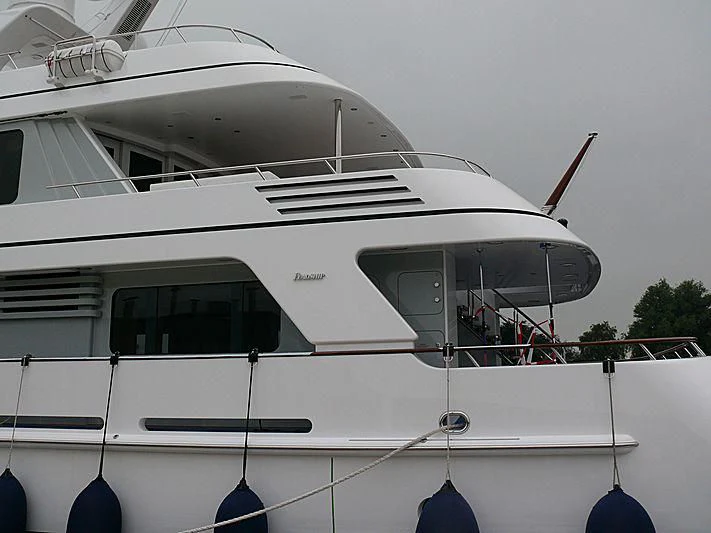 a white boat with a black and red stripe aboard OCEAN MERCURY Yacht for Sale