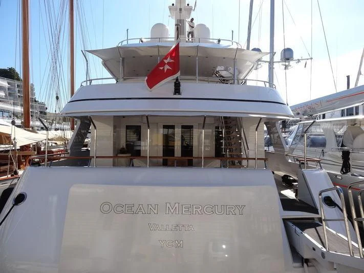 a boat with a flag on the front aboard OCEAN MERCURY Yacht for Sale