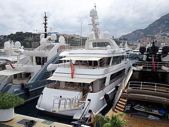 a couple of boats are parked at a dock aboard OCEAN MERCURY Yacht for Sale
