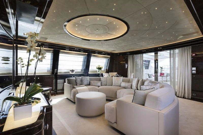 a living room with a large chandelier aboard ELSEA Yacht for Sale
