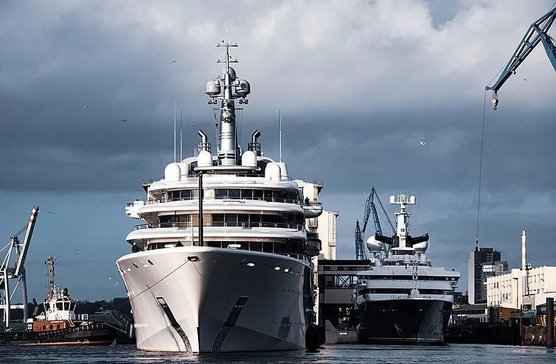 a large white ship in a harbor aboard ECLIPSE Yacht for Sale