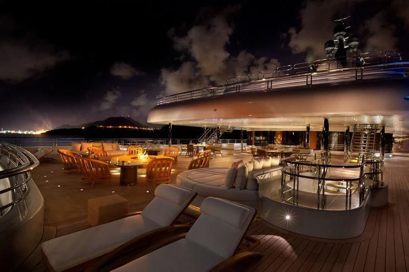 a deck with a view of a city at night aboard ECLIPSE Yacht for Sale