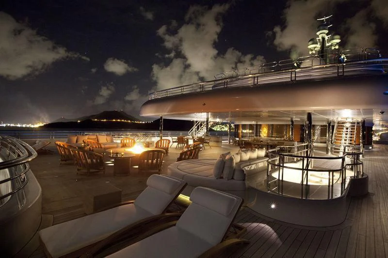 a deck with a view of a city at night aboard ECLIPSE Yacht for Sale