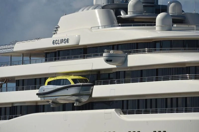 a white building with a yellow car parked on the front aboard ECLIPSE Yacht for Sale