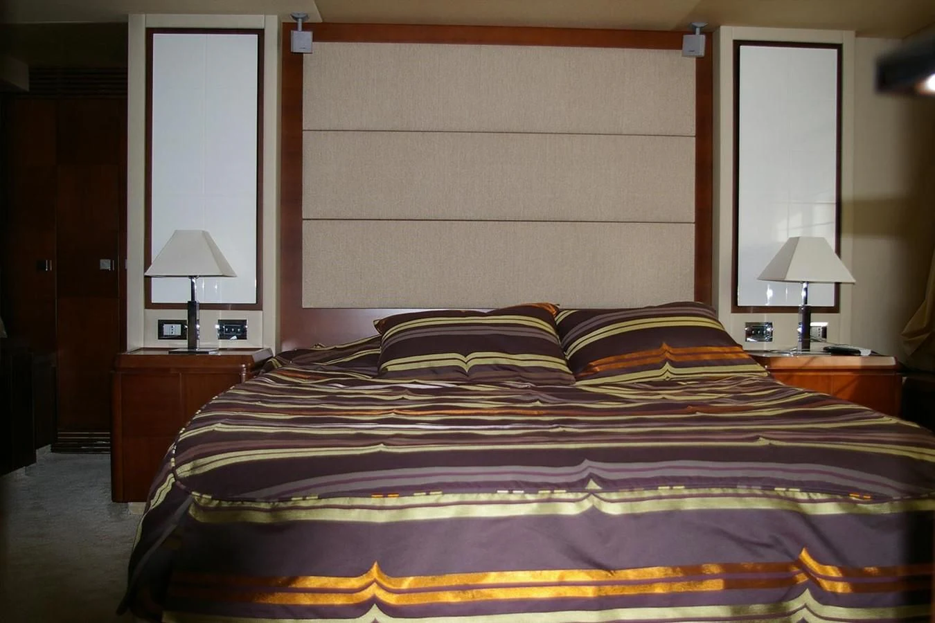 a bed with a blue comforter aboard VICTORIA V Yacht for Sale