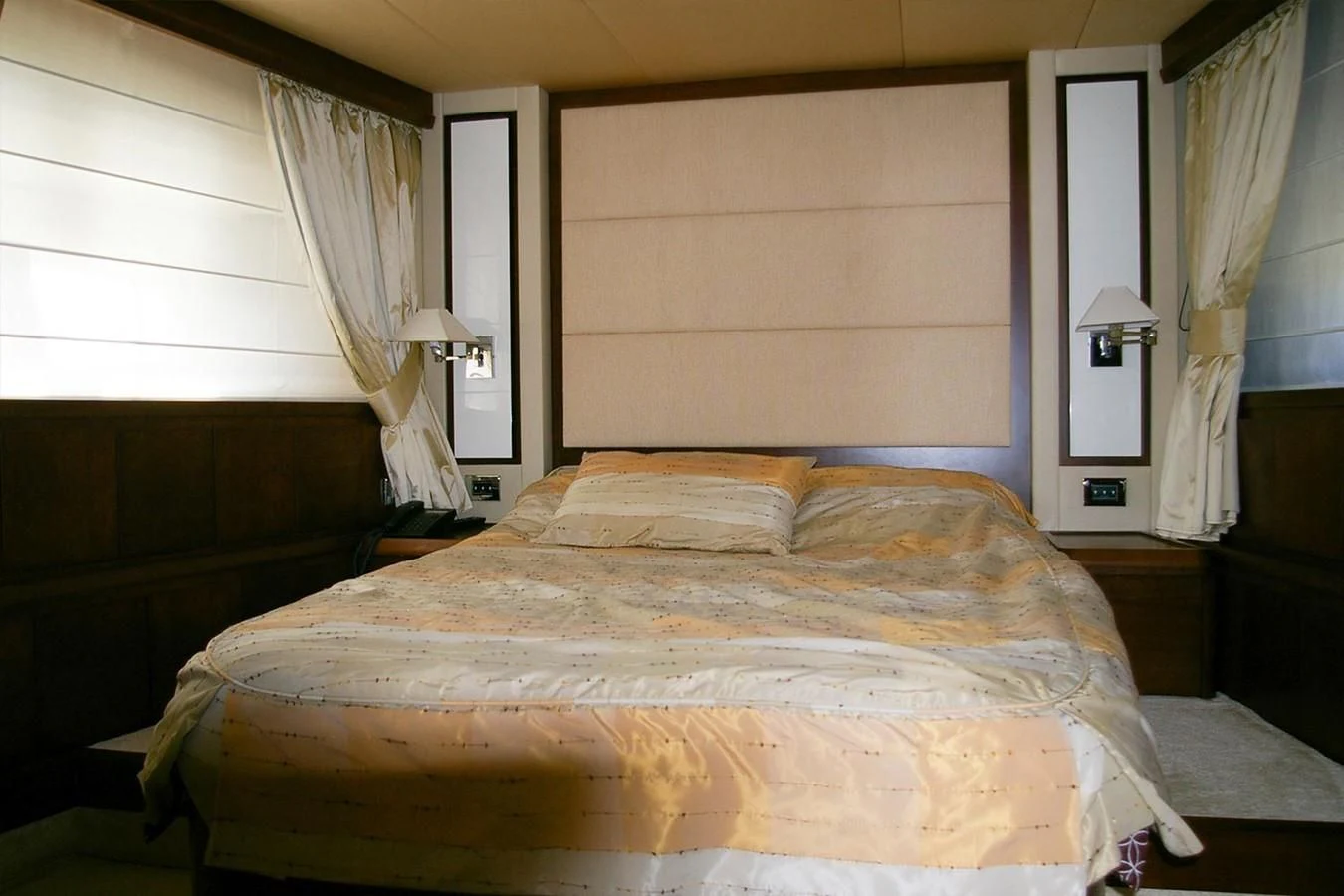 a bed with a lamp on the side aboard VICTORIA V Yacht for Sale