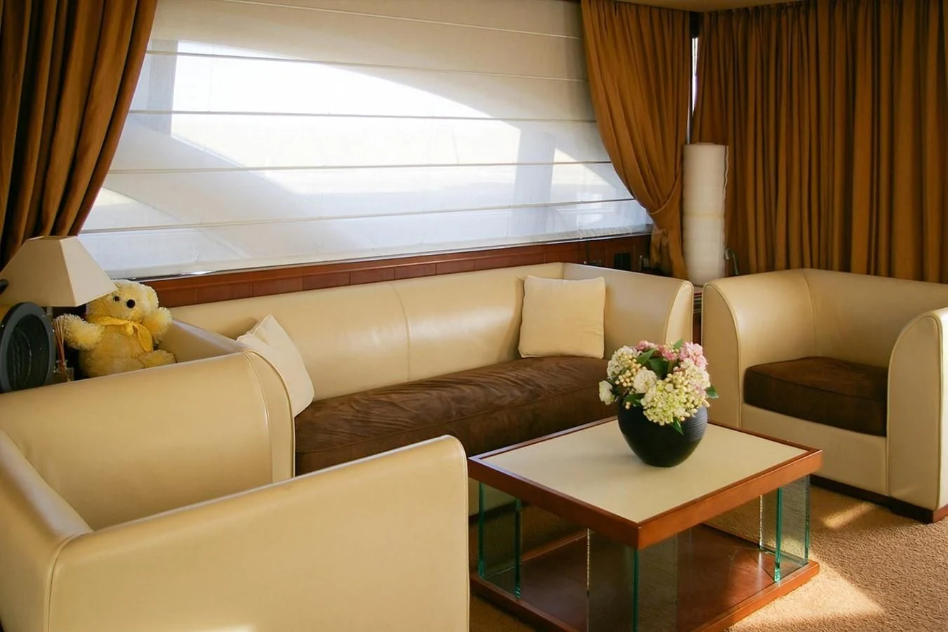 a living room with a couch and a coffee table aboard VICTORIA V Yacht for Sale