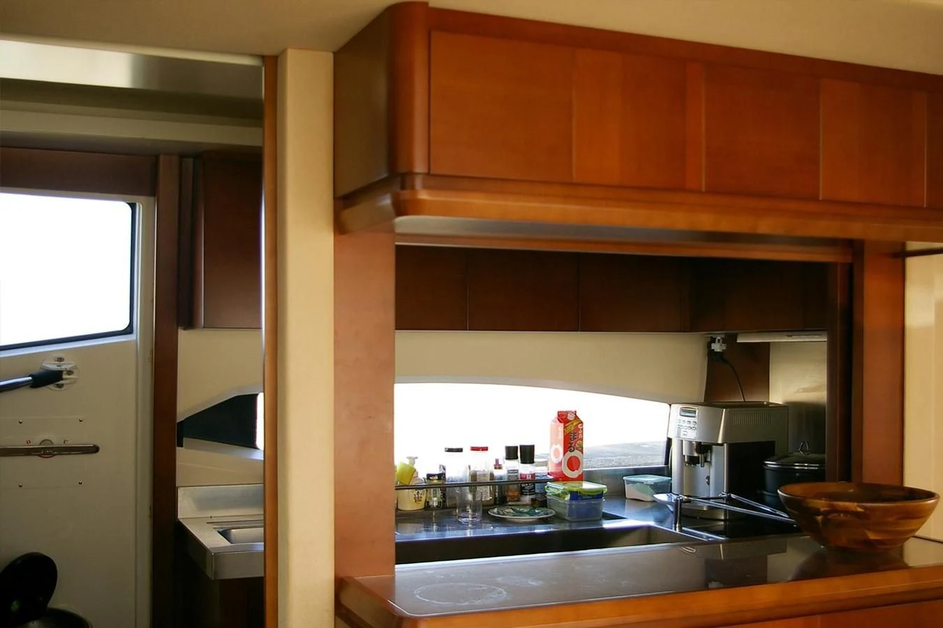 a kitchen with wooden cabinets aboard VICTORIA V Yacht for Sale