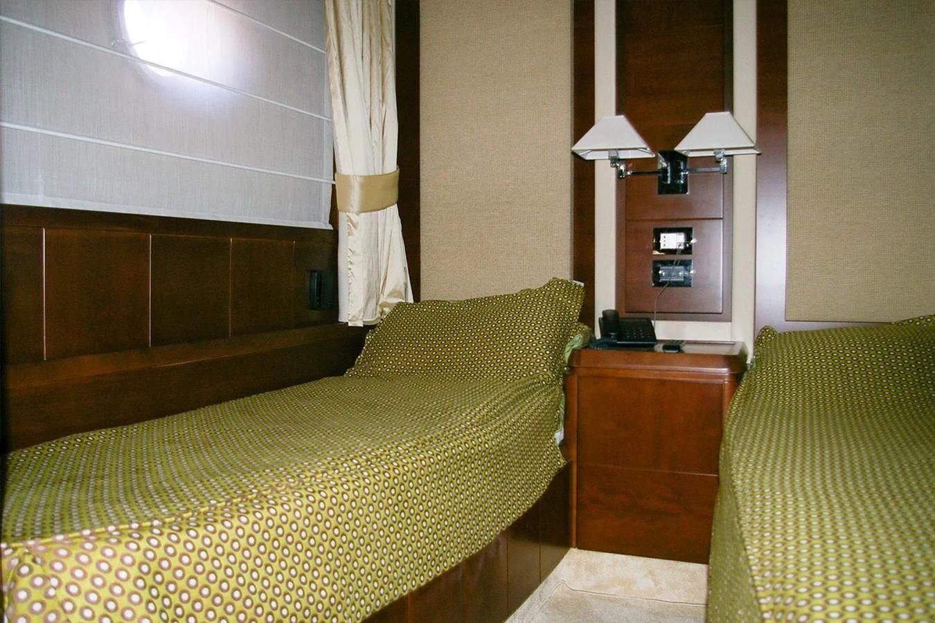 a bedroom with a bed and a lamp aboard VICTORIA V Yacht for Sale