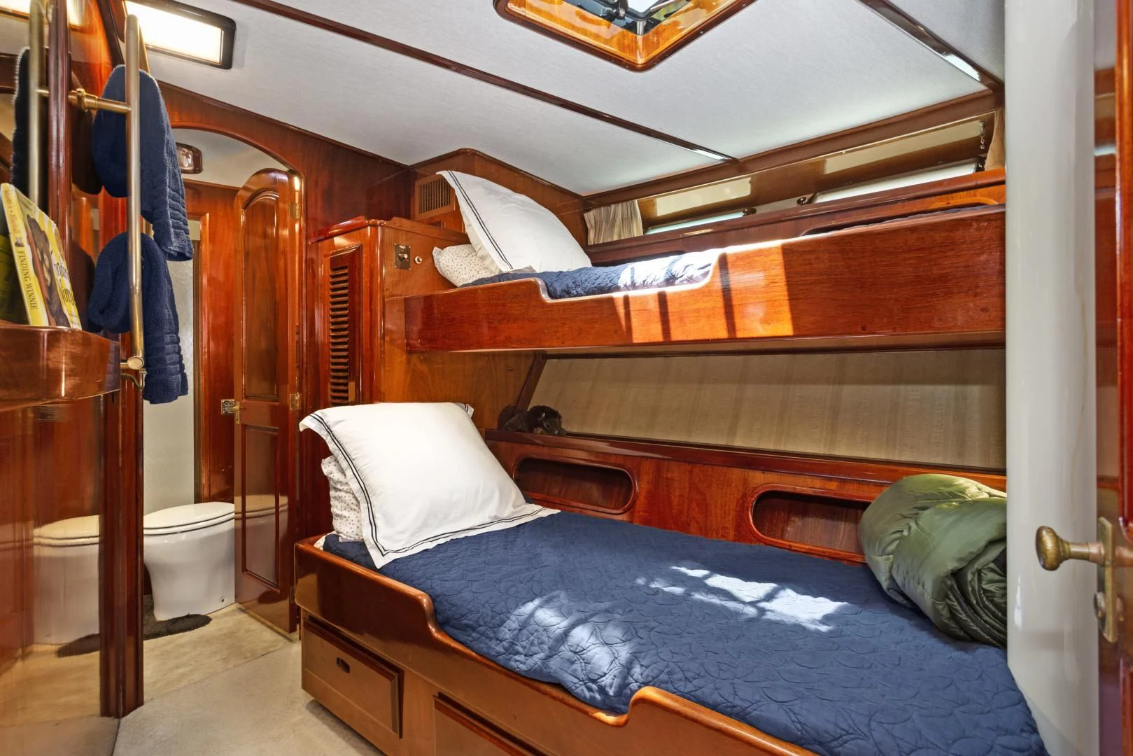 a bed with a blue sheet aboard EL AMO Yacht for Sale