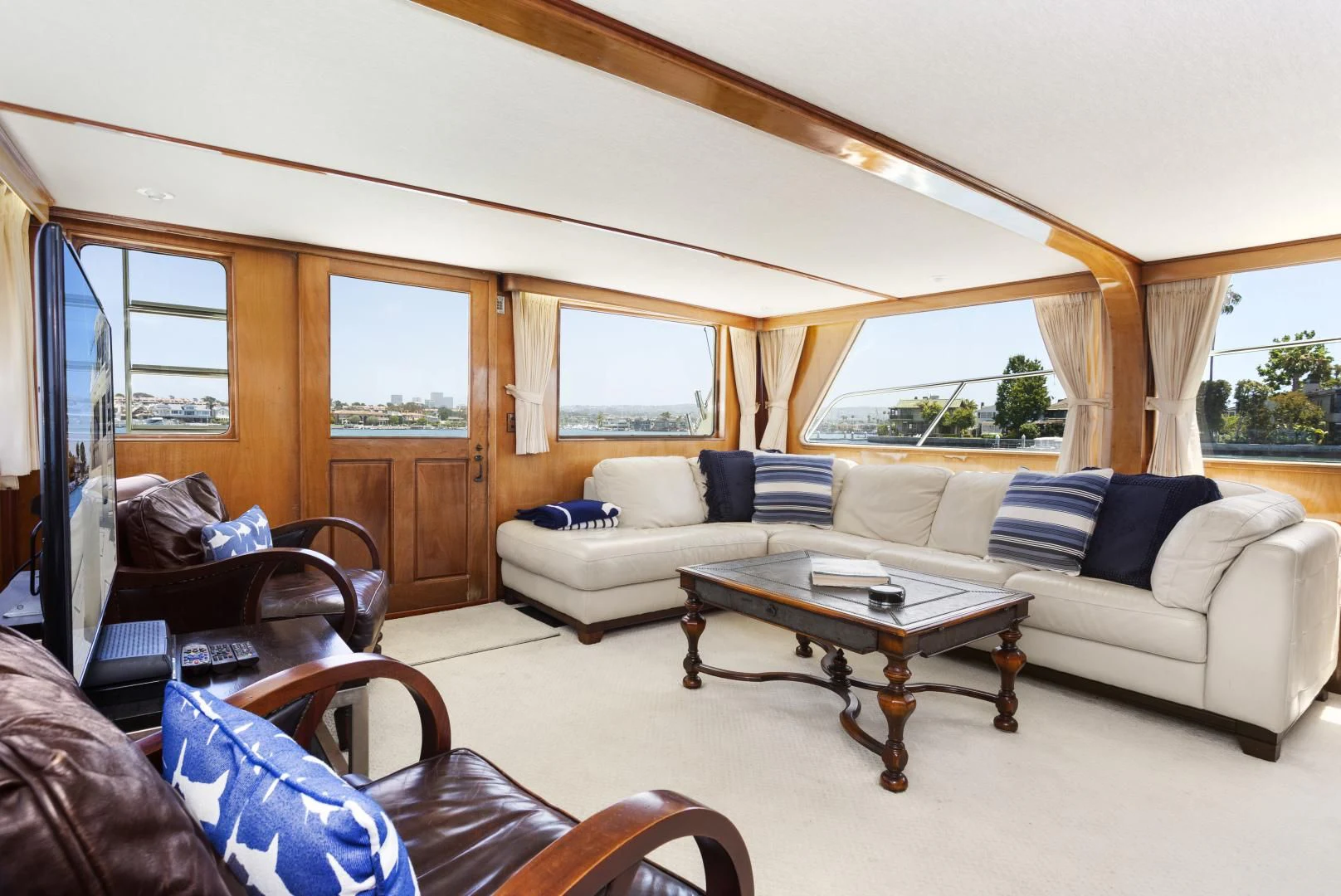 a living room with a couch and a coffee table aboard EL AMO Yacht for Sale