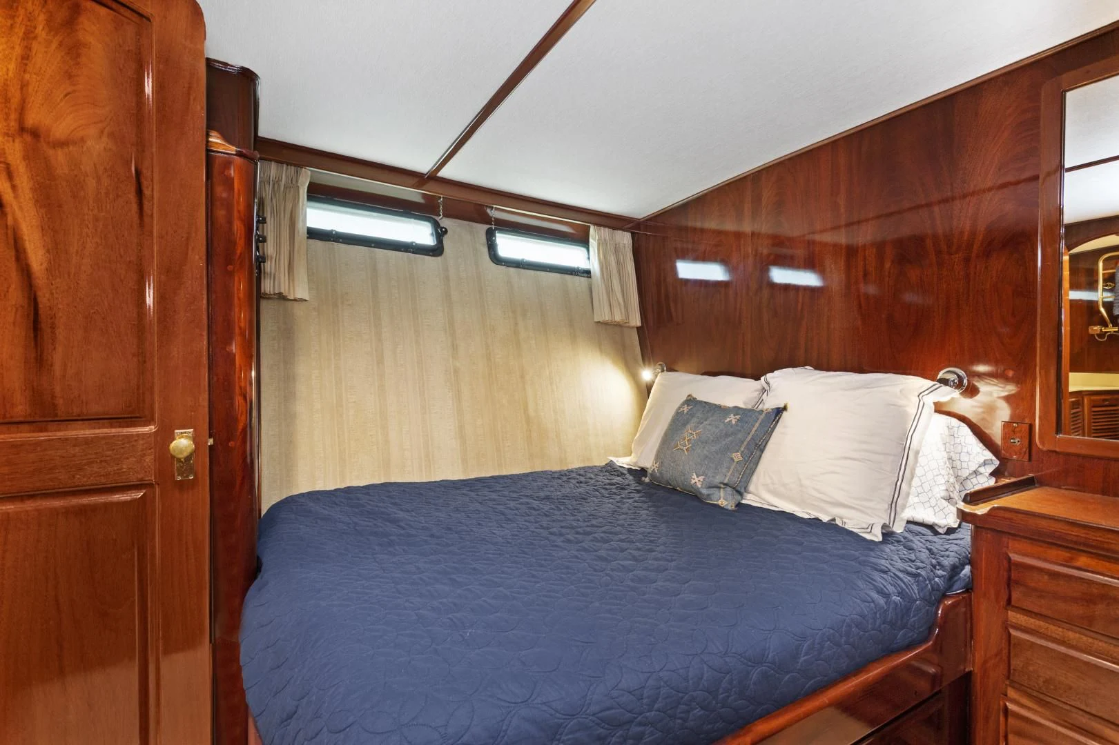 a bed with a blue comforter aboard EL AMO Yacht for Sale