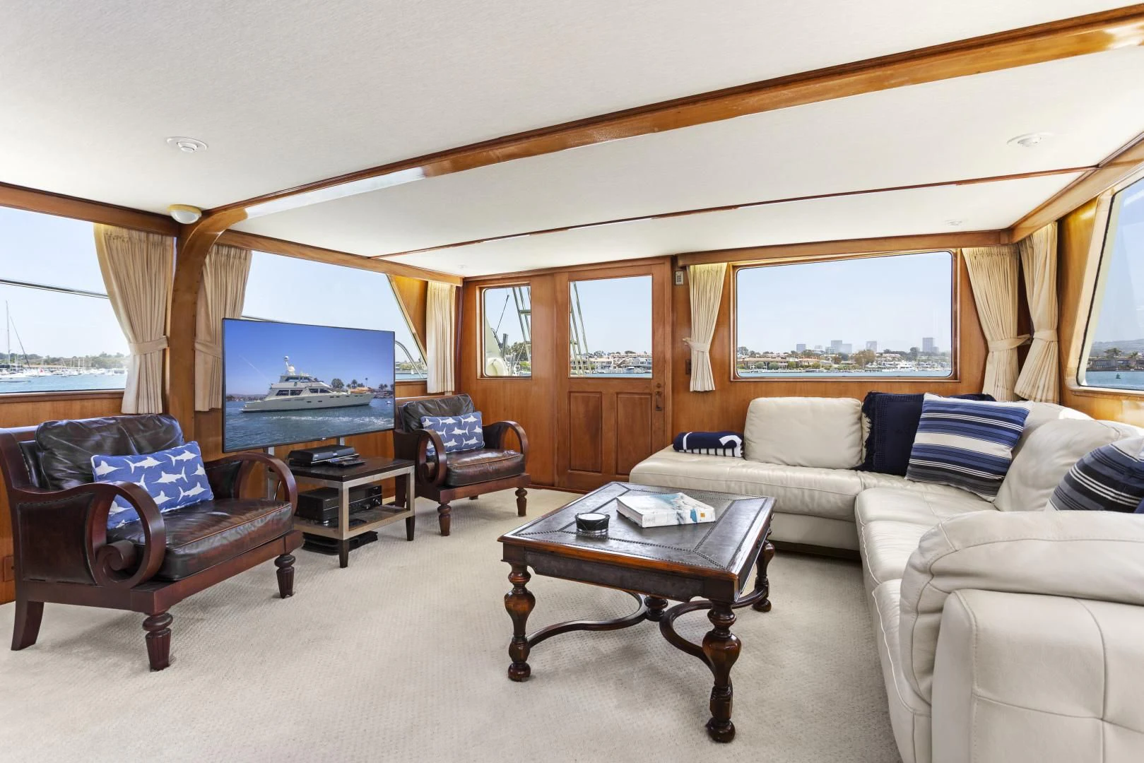 a living room with a couch and a television aboard EL AMO Yacht for Sale