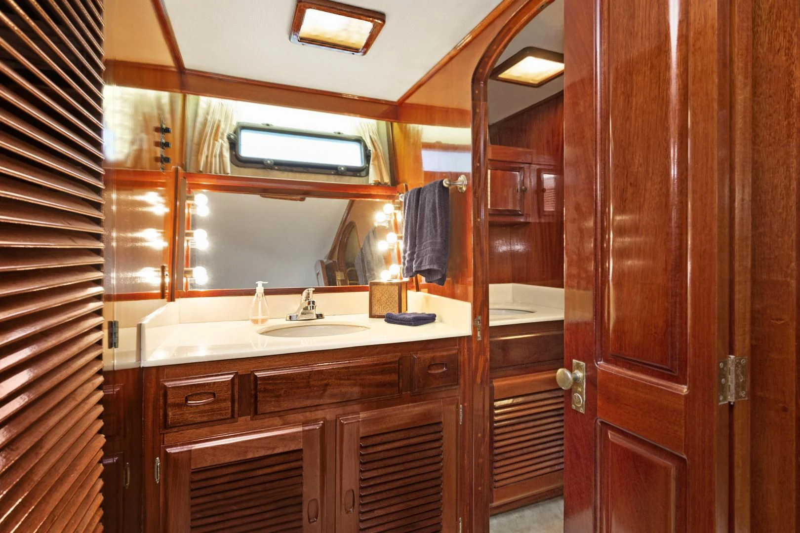 a bathroom with a sink and a mirror aboard EL AMO Yacht for Sale