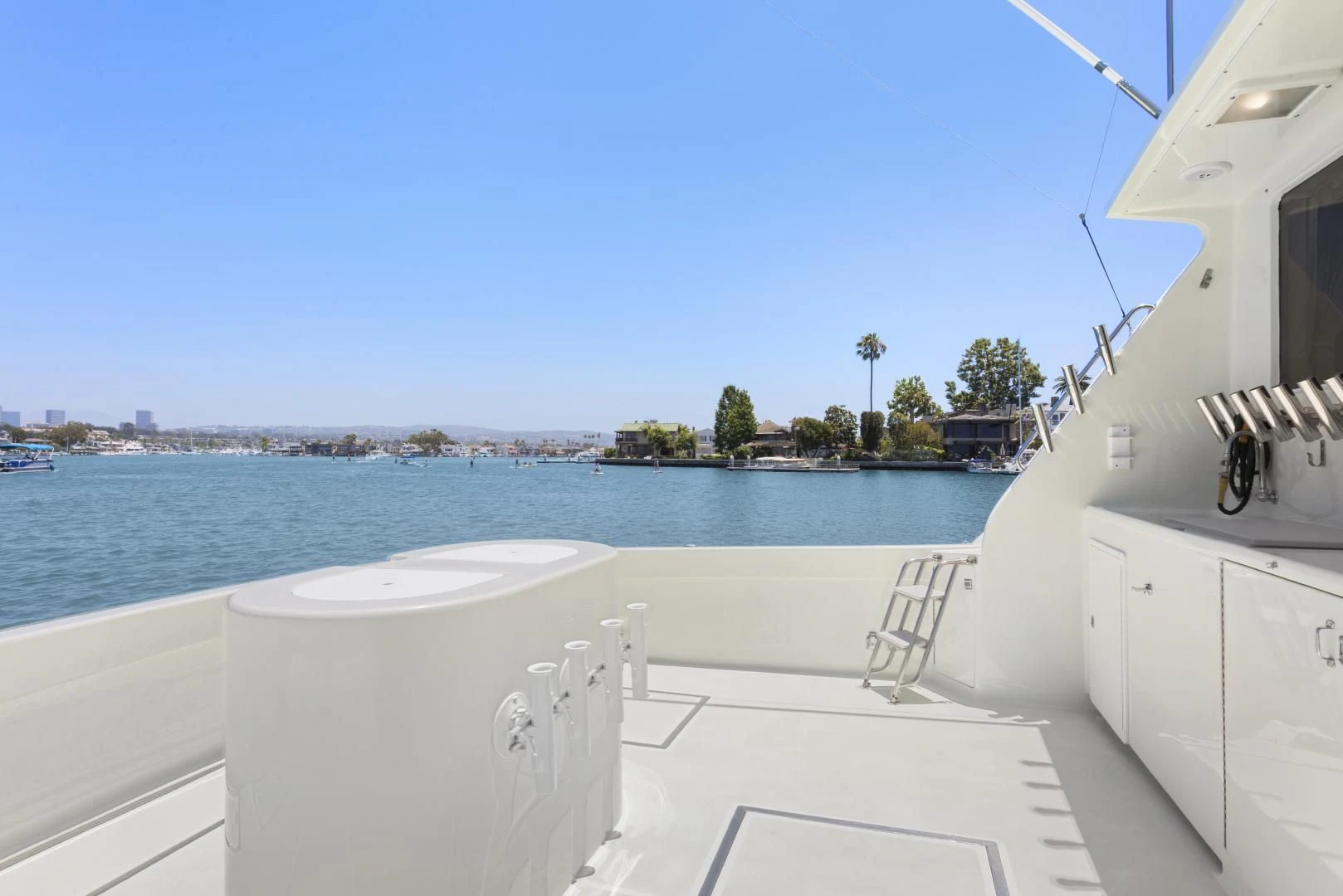 a white chair on a balcony overlooking a body of water aboard EL AMO Yacht for Sale