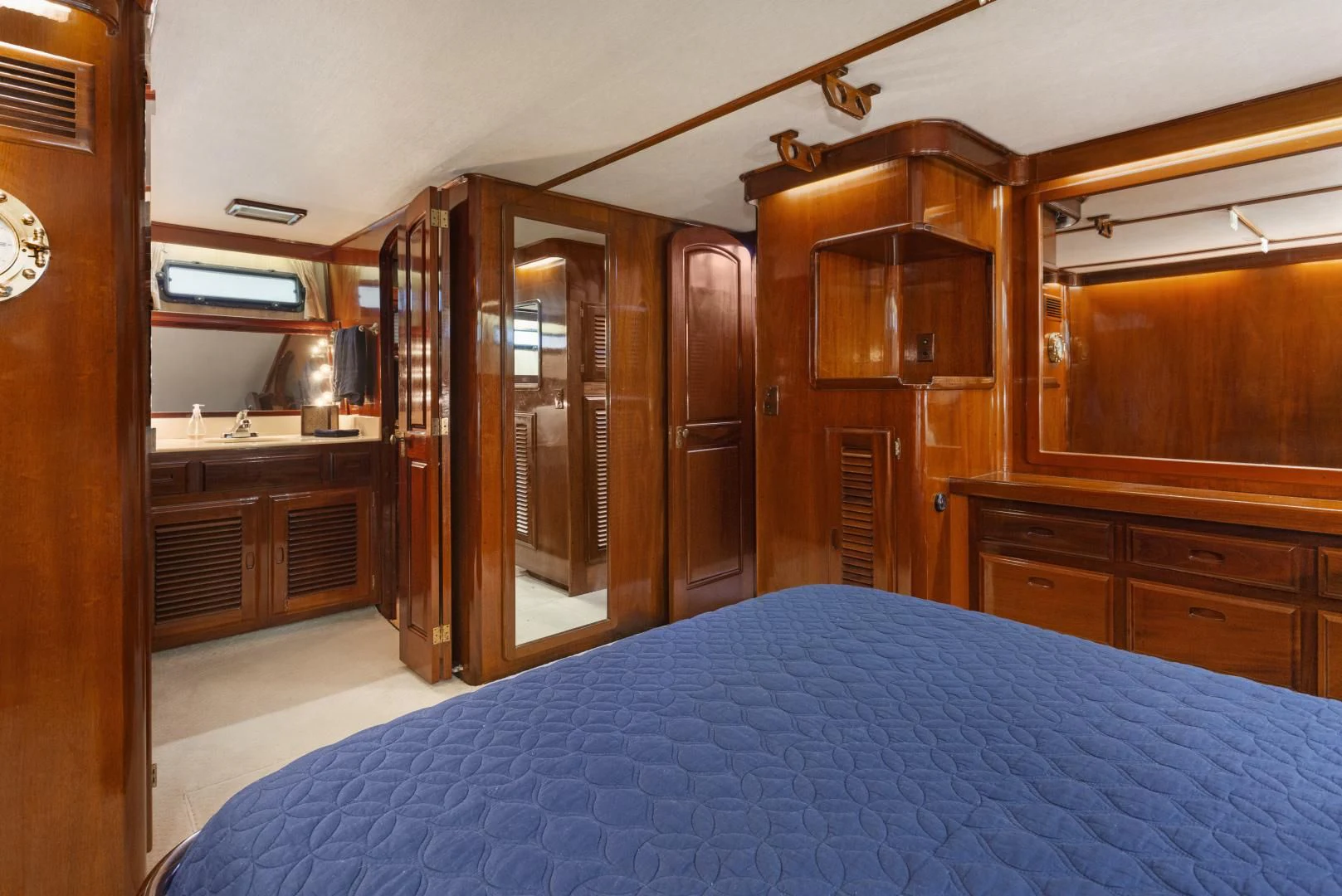a bedroom with a bed and cabinets aboard EL AMO Yacht for Sale