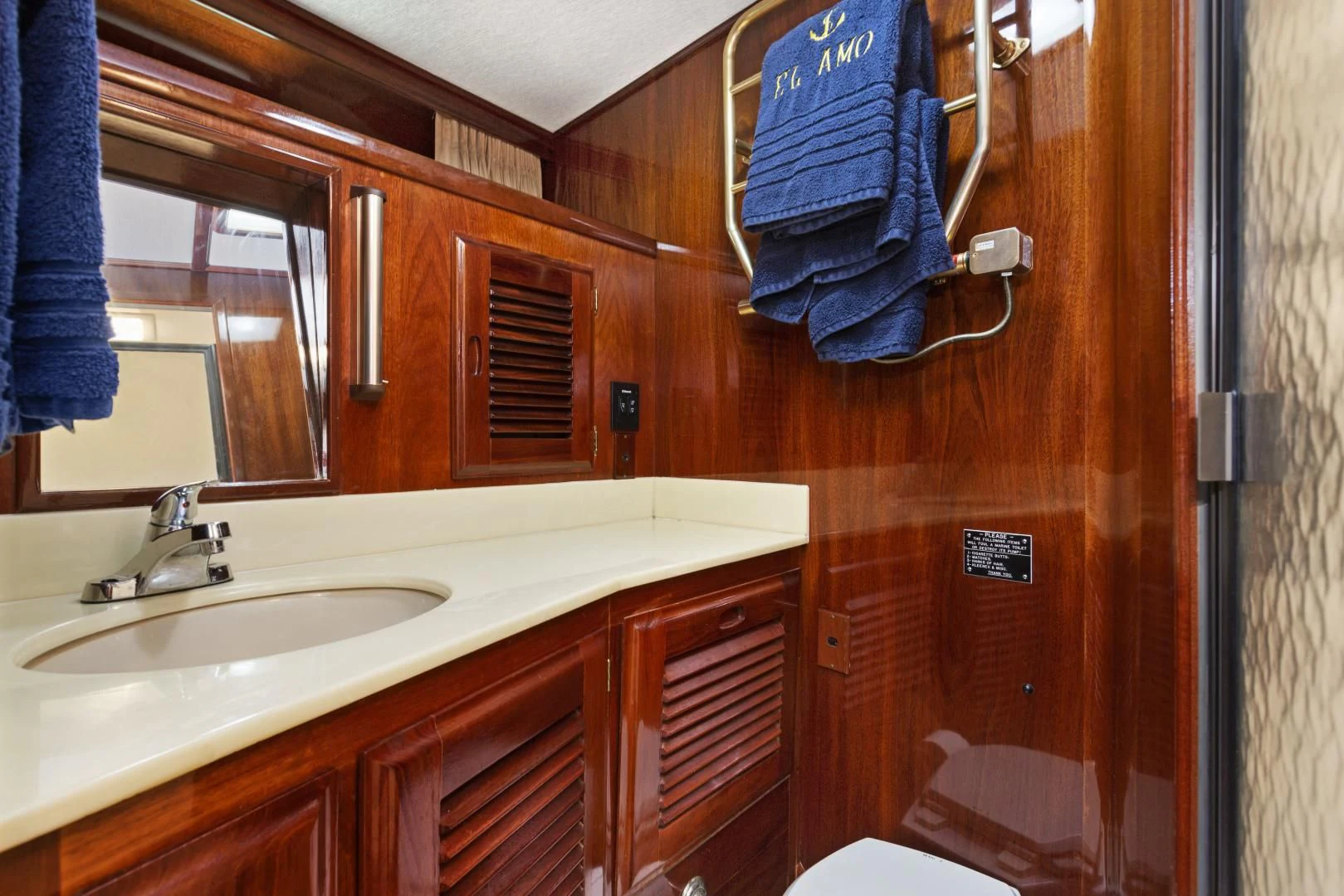a bathroom with a sink and a toilet aboard EL AMO Yacht for Sale