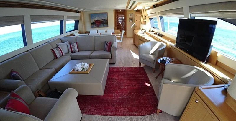 a living room with a red rug aboard CHUPRIANA Yacht for Sale