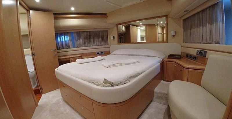 a room with a bed and a chair aboard CHUPRIANA Yacht for Sale
