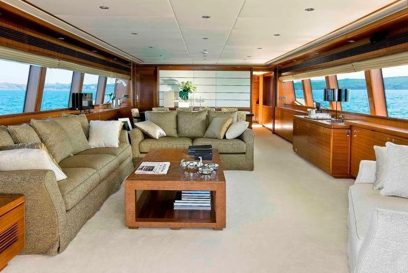 a living room with a couch and a coffee table aboard BAMBINA Yacht for Sale