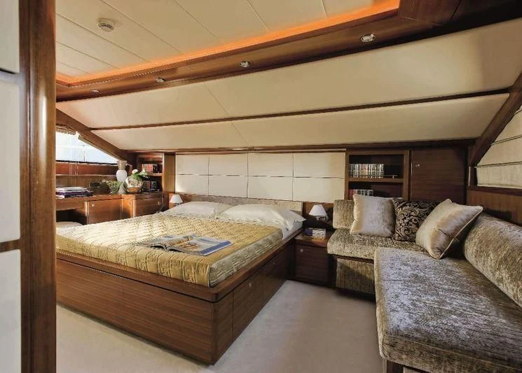 a bedroom with a bed and a couch aboard BAMBINA Yacht for Sale