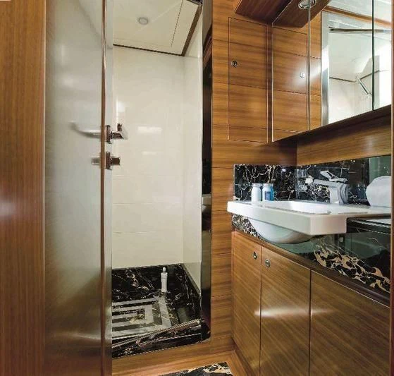 a kitchen with wooden cabinets aboard BAMBINA Yacht for Sale