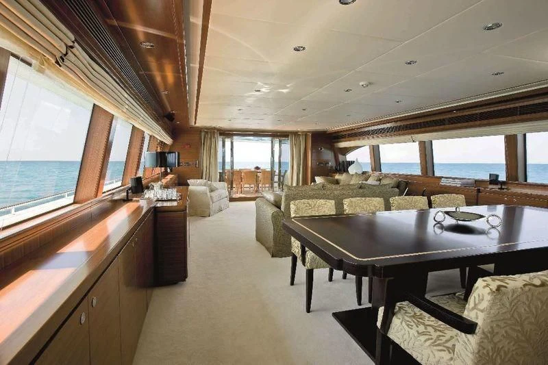 a large living room with a large table and chairs aboard BAMBINA Yacht for Sale