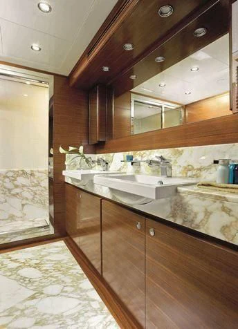 a kitchen with wooden cabinets aboard BAMBINA Yacht for Sale