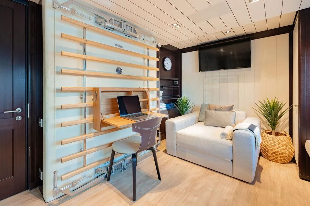 a living room with a laptop and a couch aboard GALILEO Yacht for Sale