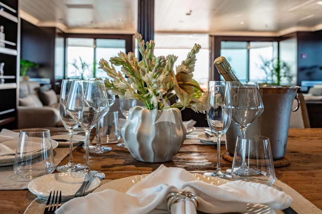 a table with silverware and glasses aboard GALILEO Yacht for Sale