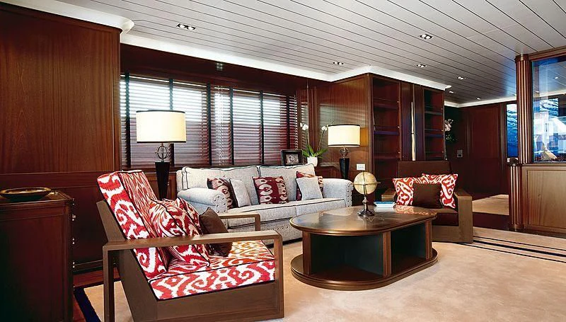 a living room with a couch and a table aboard GALILEO Yacht for Sale