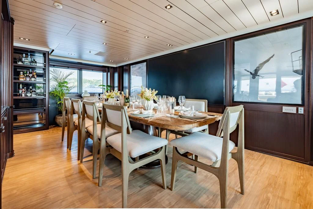 a dining room with a table and chairs aboard GALILEO Yacht for Sale