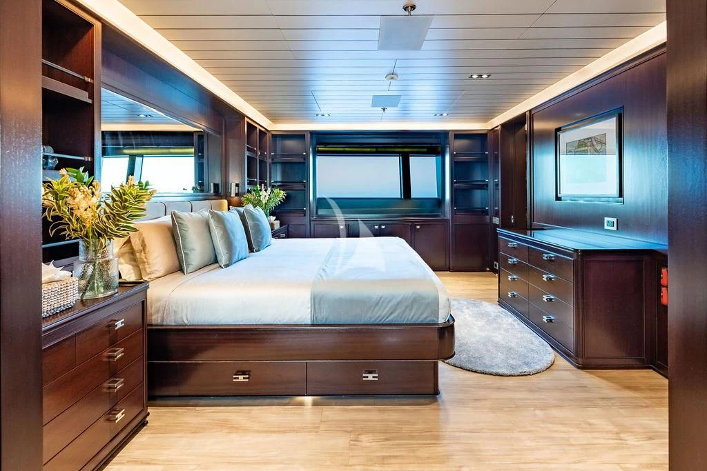 a bedroom with a bed and a desk aboard GALILEO Yacht for Sale