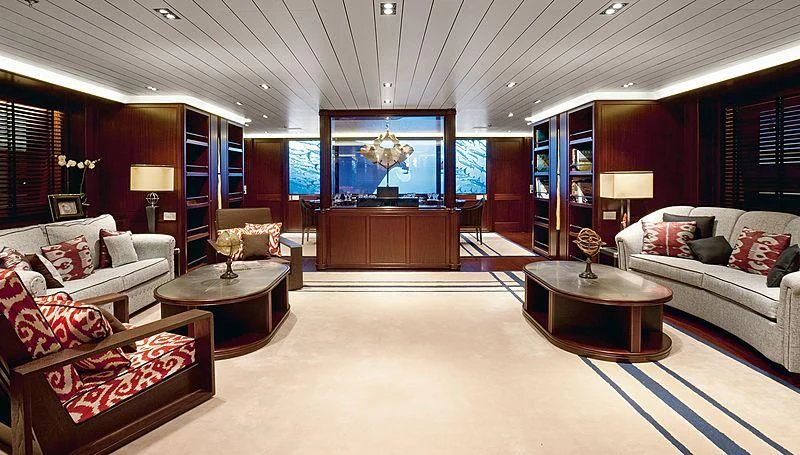 a living room with a large white couch and a large television aboard GALILEO Yacht for Sale