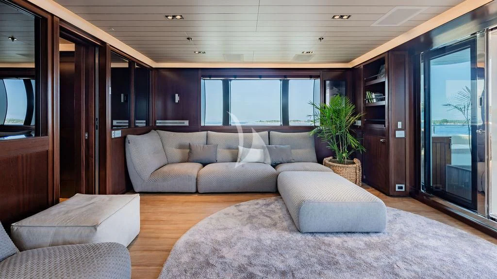 a living room with a couch and a plant aboard GALILEO Yacht for Sale