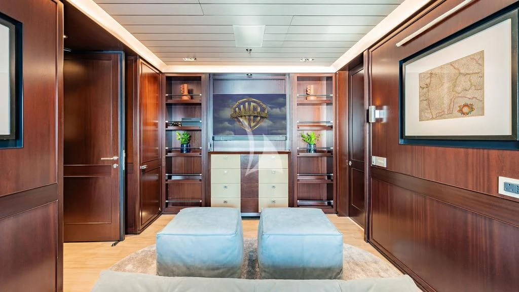 a room with a couch and a bookcase aboard GALILEO Yacht for Sale