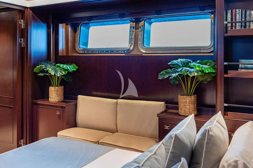 a room with a couch and a plant in it aboard GALILEO Yacht for Sale