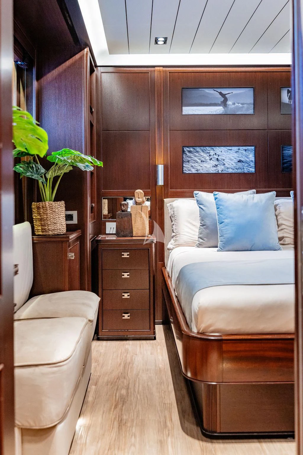 a room with a bed and a plant in it aboard GALILEO Yacht for Sale