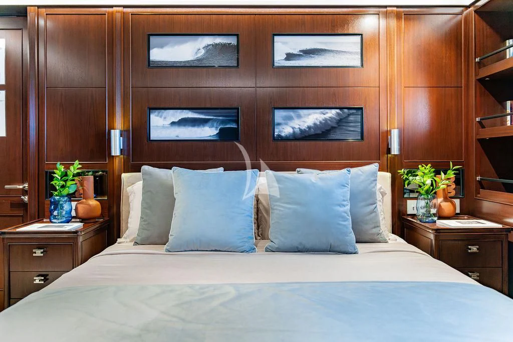 a bed with white sheets and pillows aboard GALILEO Yacht for Sale