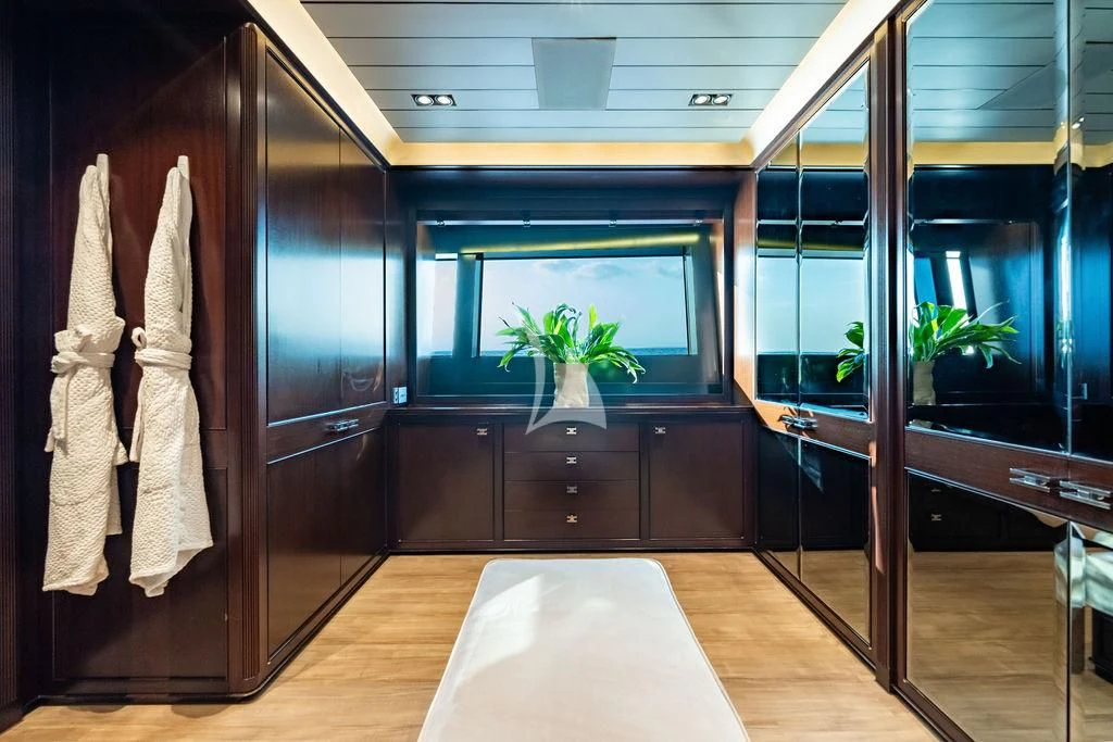 a room with a large mirror and a plant in the window aboard GALILEO Yacht for Sale