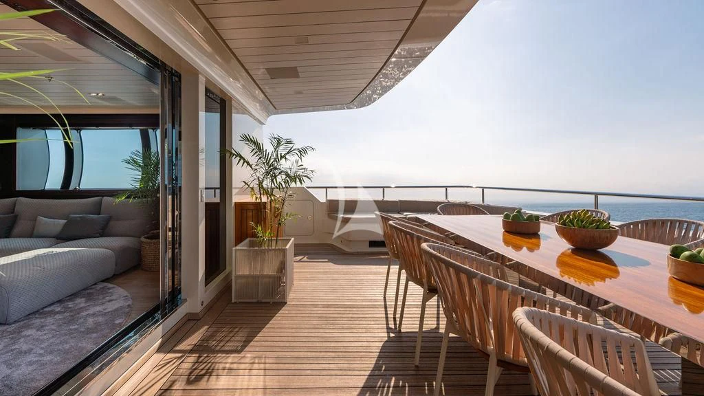 a large room with a table and chairs and a couch aboard GALILEO Yacht for Sale