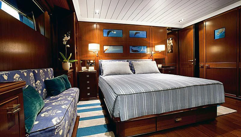 a bedroom with a bed and a couch aboard GALILEO Yacht for Sale