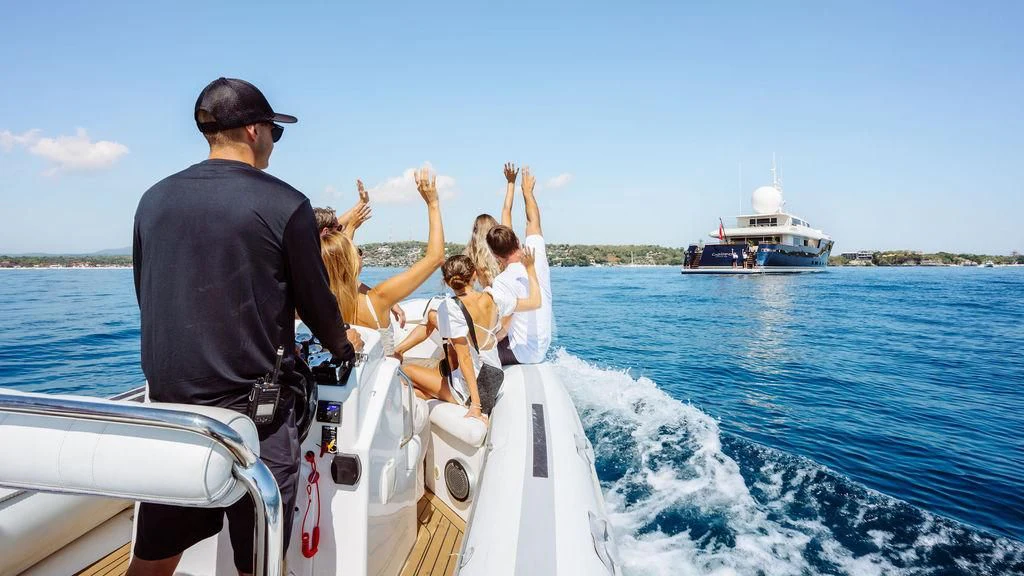 a man and a woman on a boat with a group of children on it aboard GALILEO Yacht for Sale