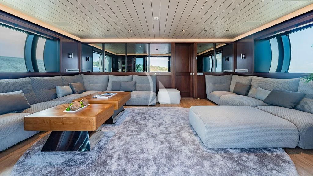 a living room with a couch and a table aboard GALILEO Yacht for Sale
