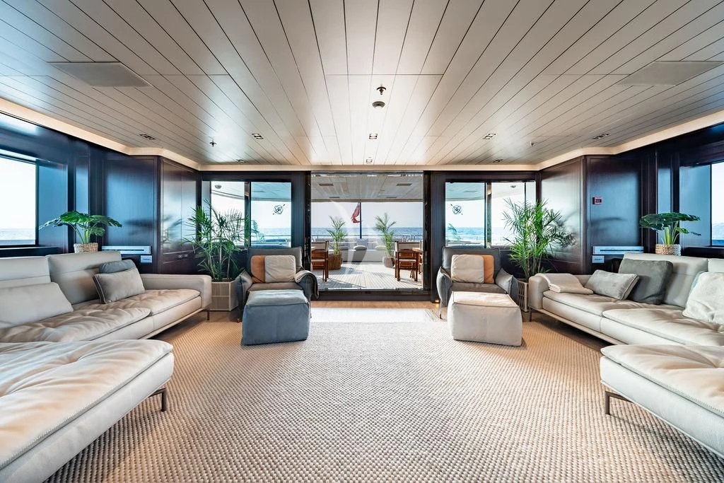 a large living room with a large white rug aboard GALILEO Yacht for Sale