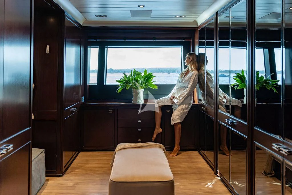 a man and woman dancing in a room with glass walls aboard GALILEO Yacht for Sale
